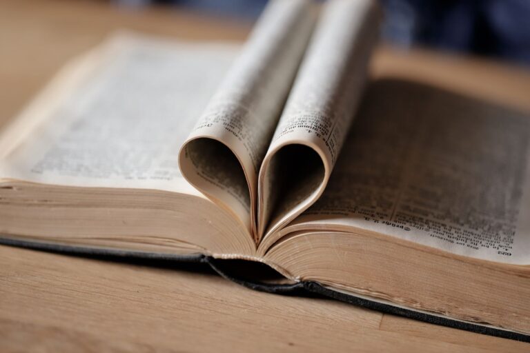 heart shaped book pages on wooden table