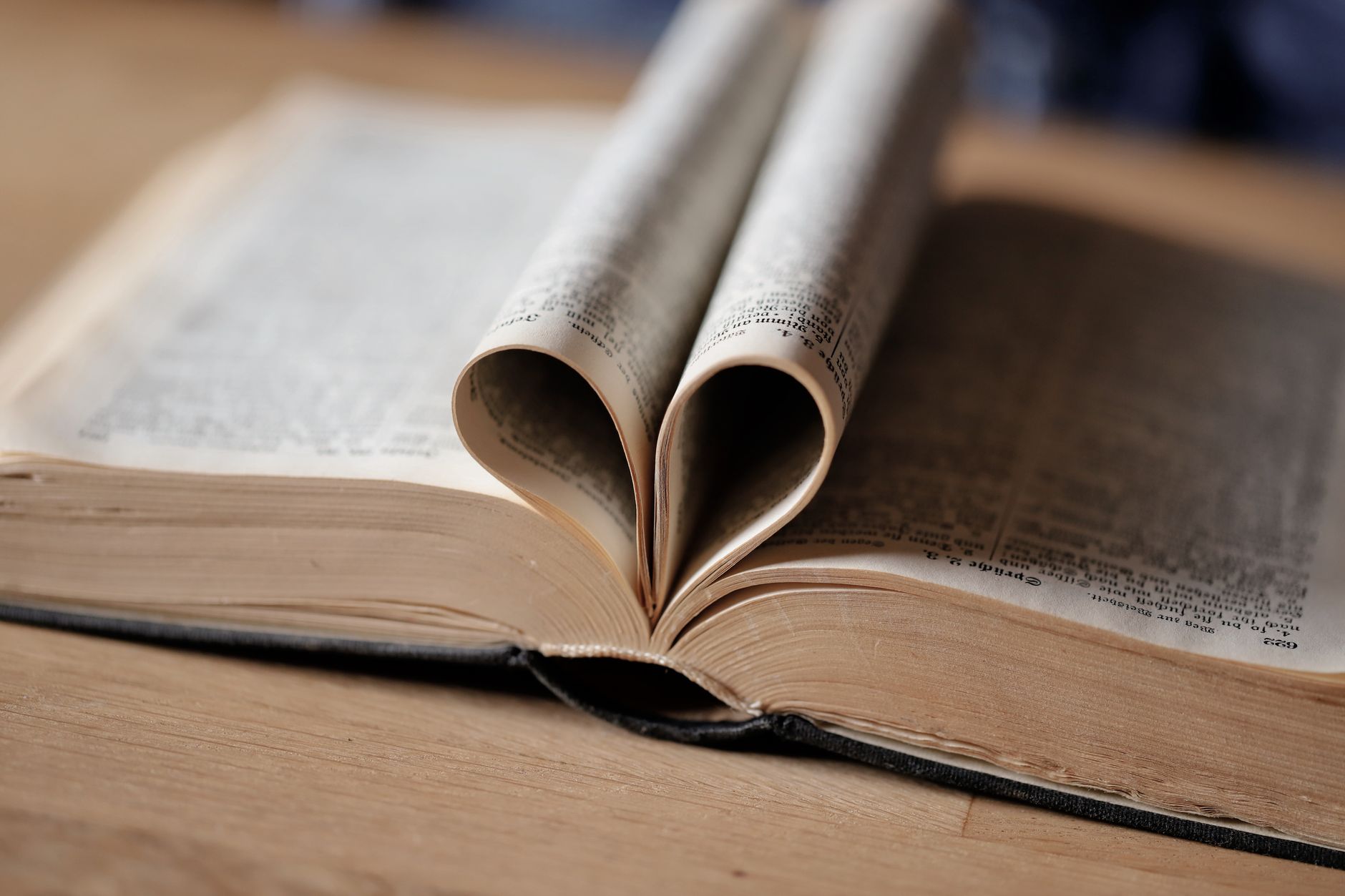 heart shaped book pages on wooden table